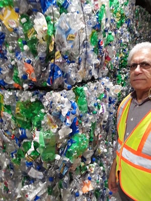 George Smilow, COO of Polyquest Recycling, stands by stack of PET bales from redemption centers at PQ’s plant on Long Island.